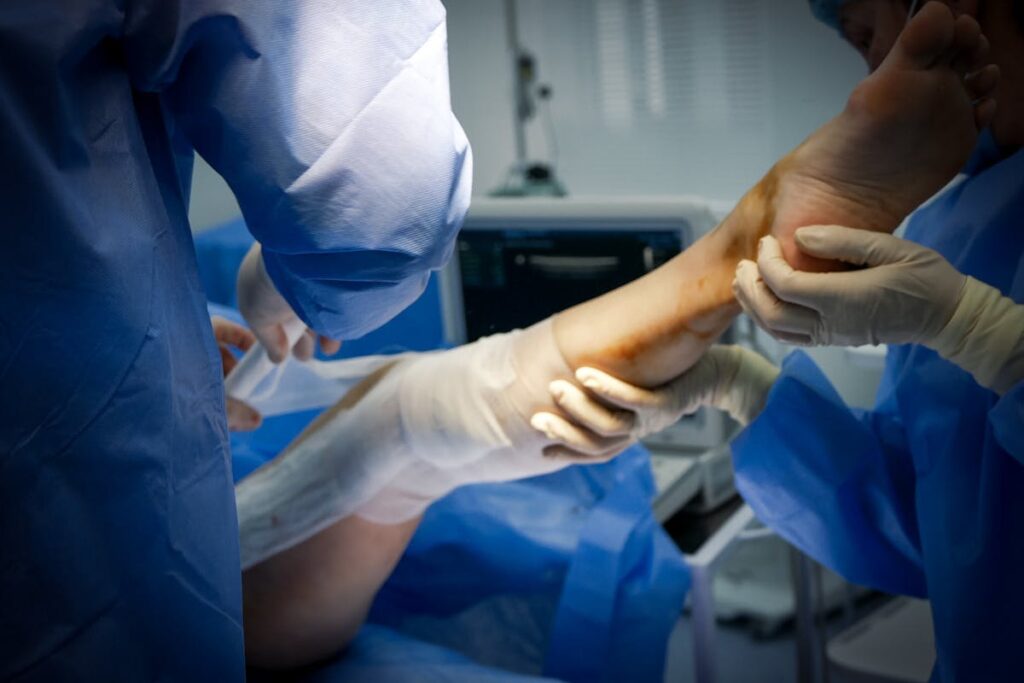 Doctors Treating Leg of Patient