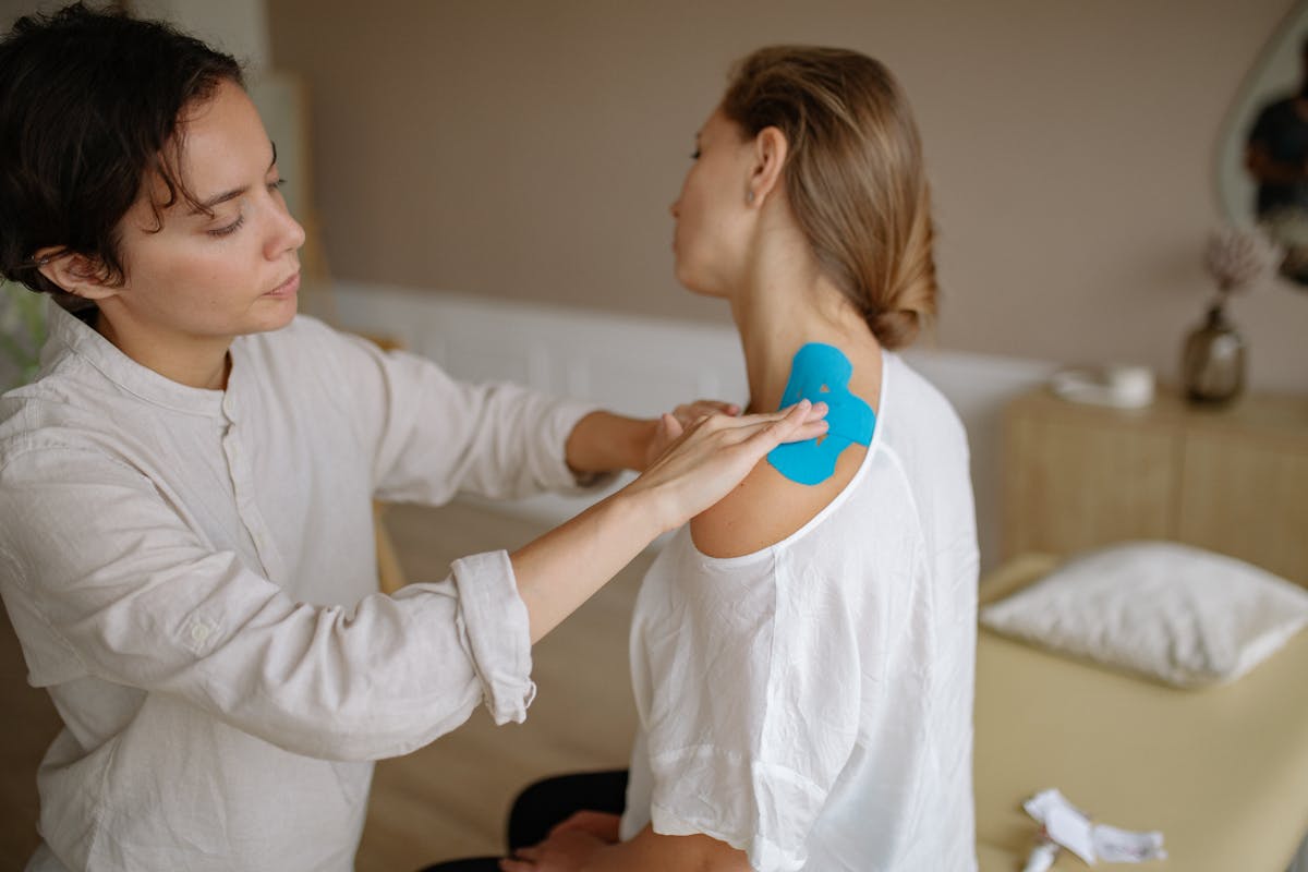 Woman Taping Client Back